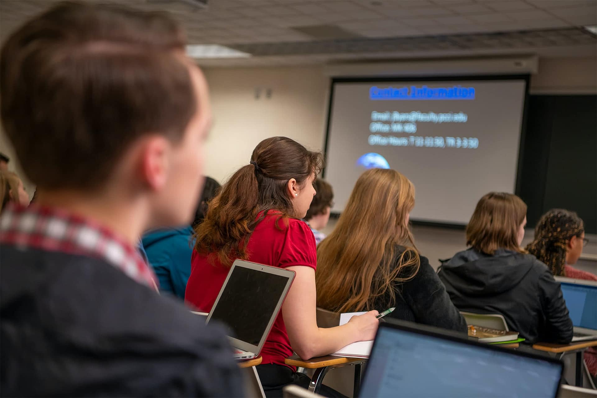 Behind view of students sitting at desks.