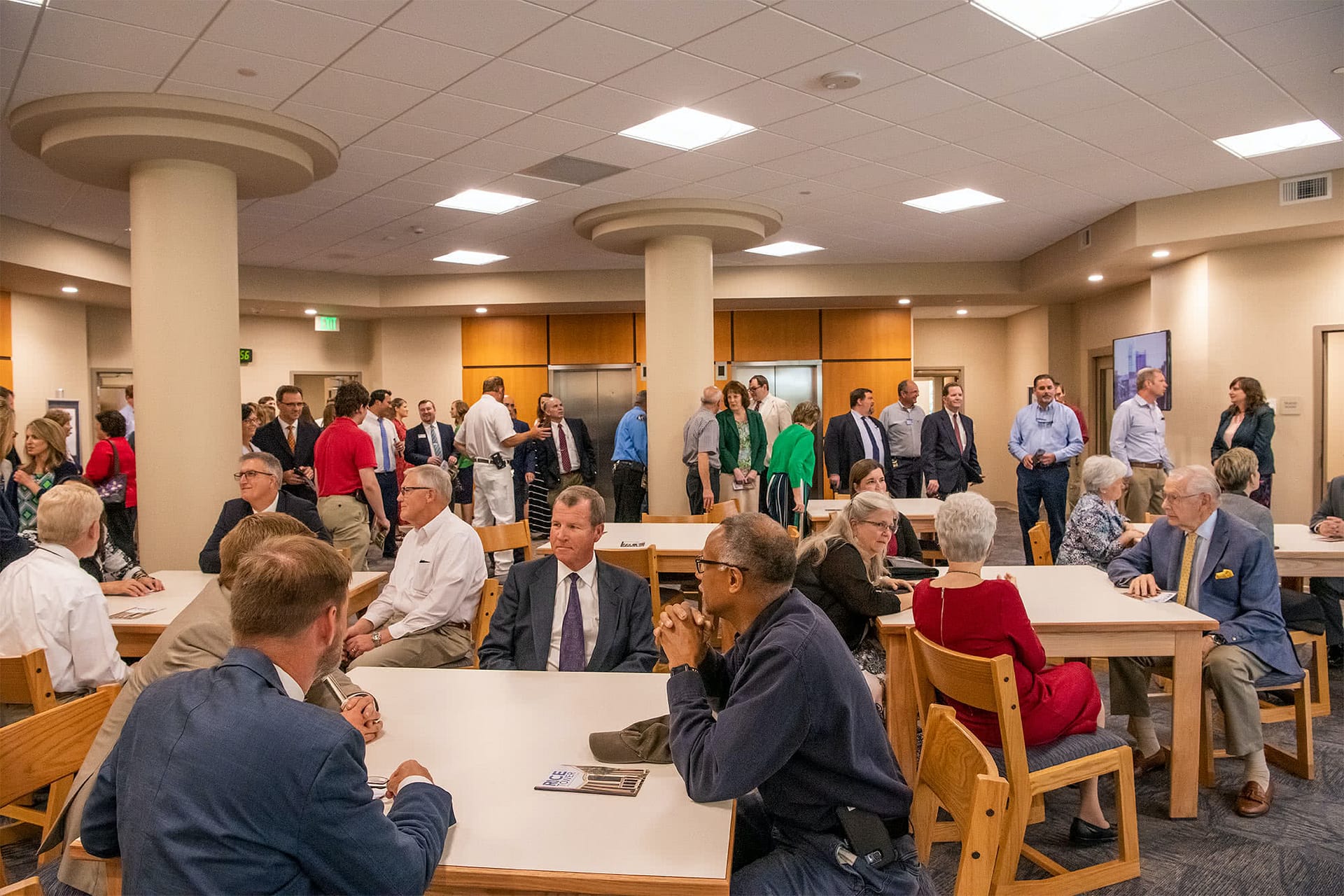A group gathered in the Rice Tower lobby for the dedication ceremony.