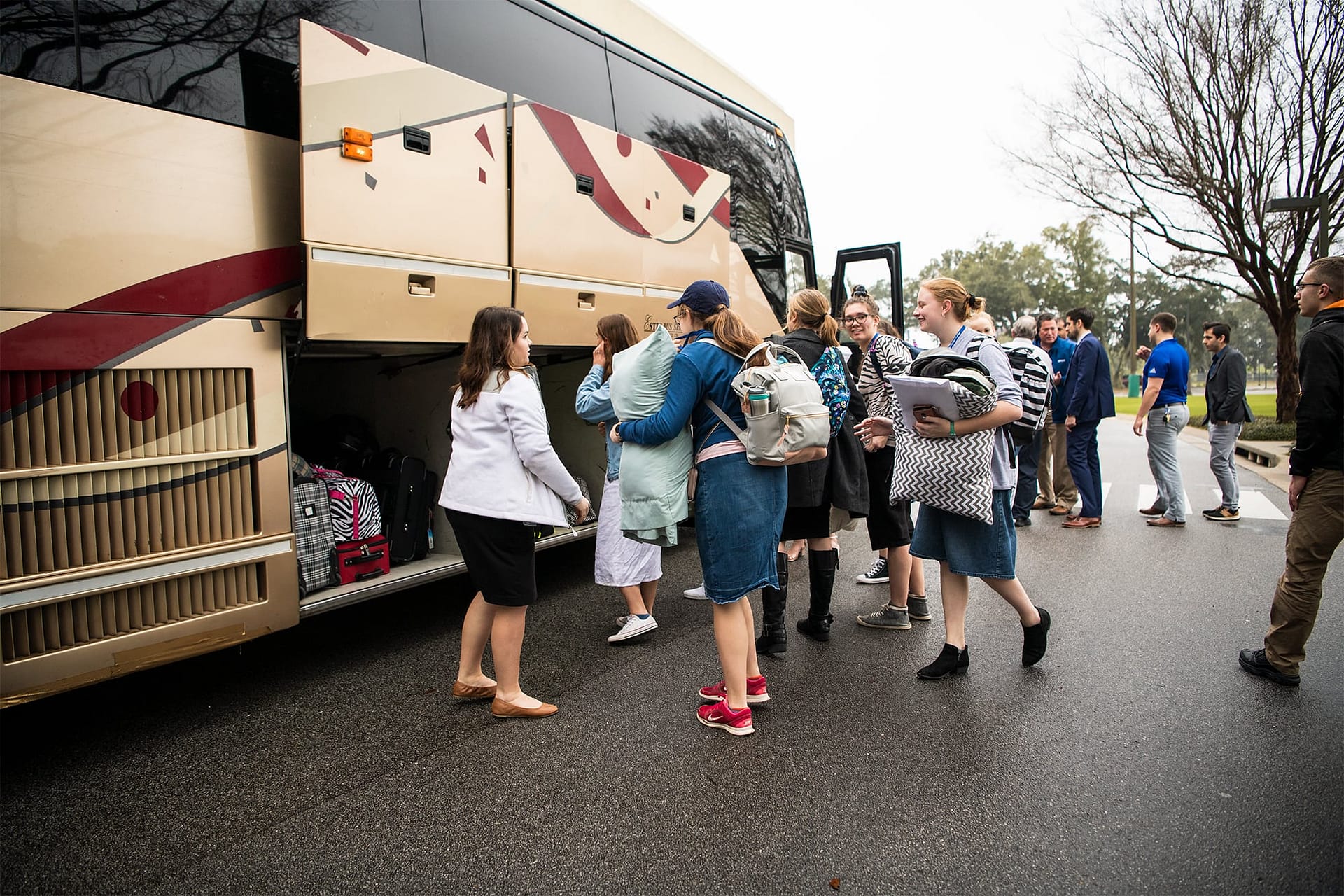 Students unloading a bus after arriving for College Getaway.