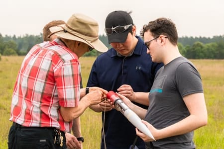 Dr. Keith Francis works with students to launch a rocket.