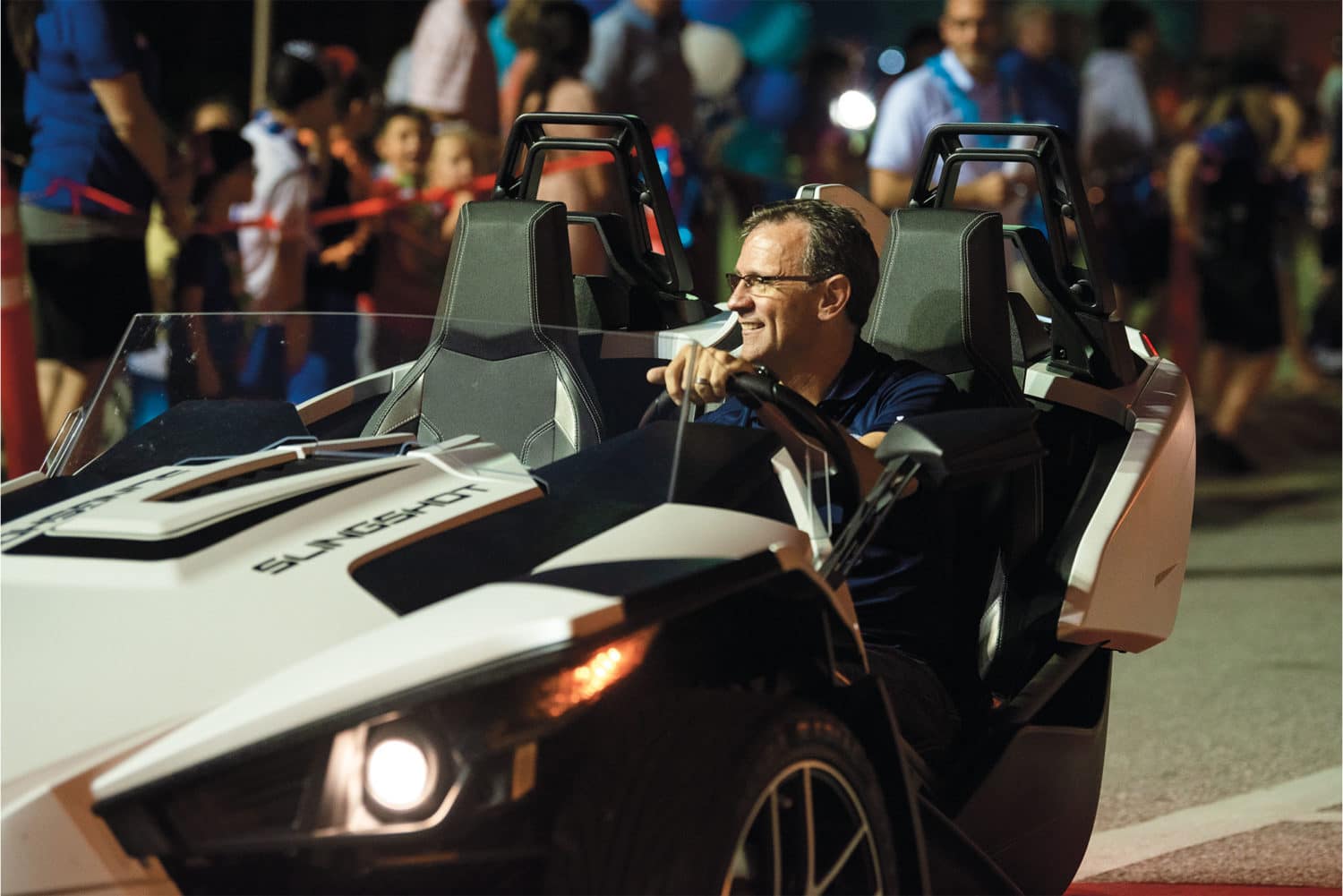 Pastor Redlin in a car in the Greek Rush Parade..