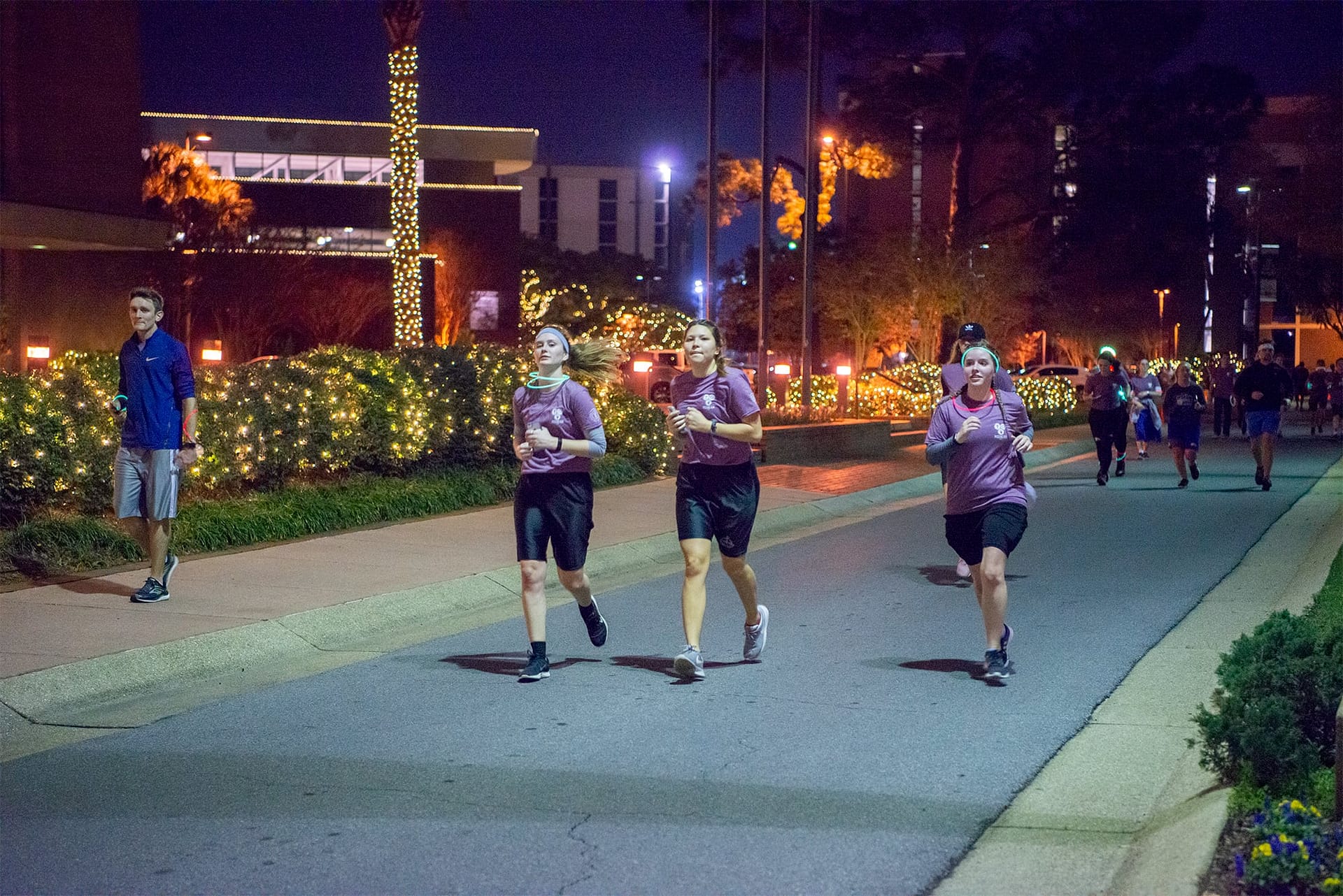 Three students pass in front of the Administration building