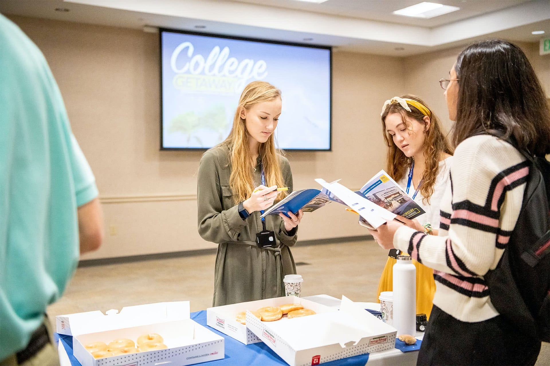 Students looking at College Getaway booklets.