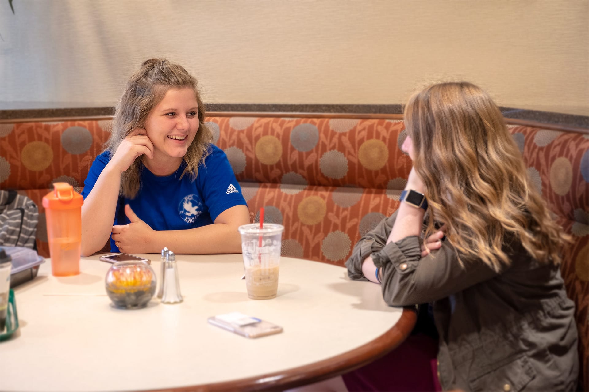 Girls talking over coffee.