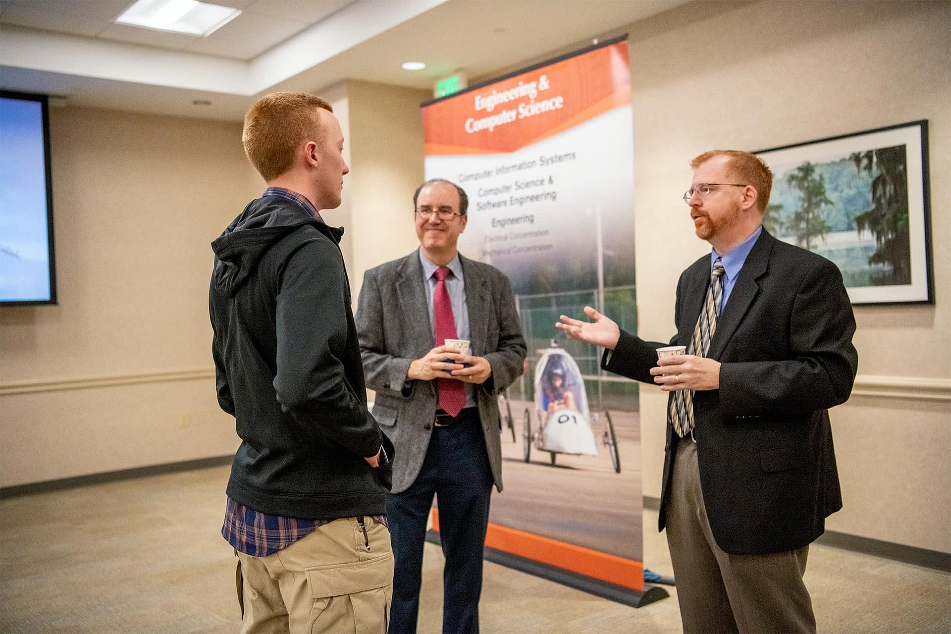 A student talking to PCC faculty members.