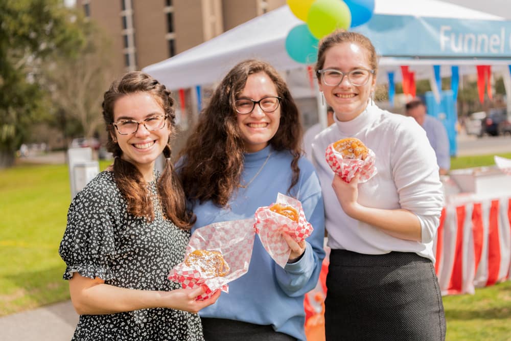 Girls enjoy funnel cake at the Bible Conference Picnic