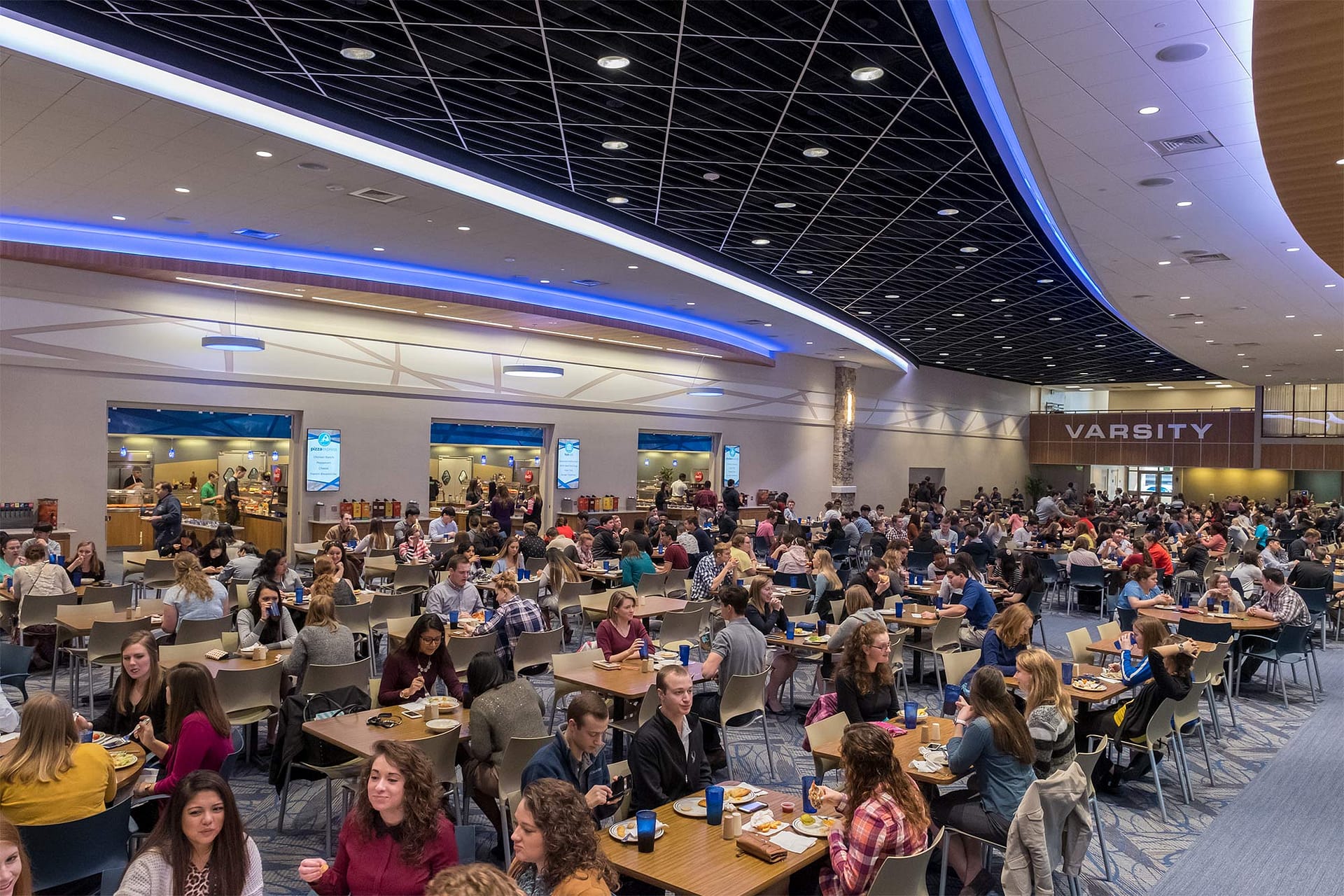 Students eating in a dining hall.