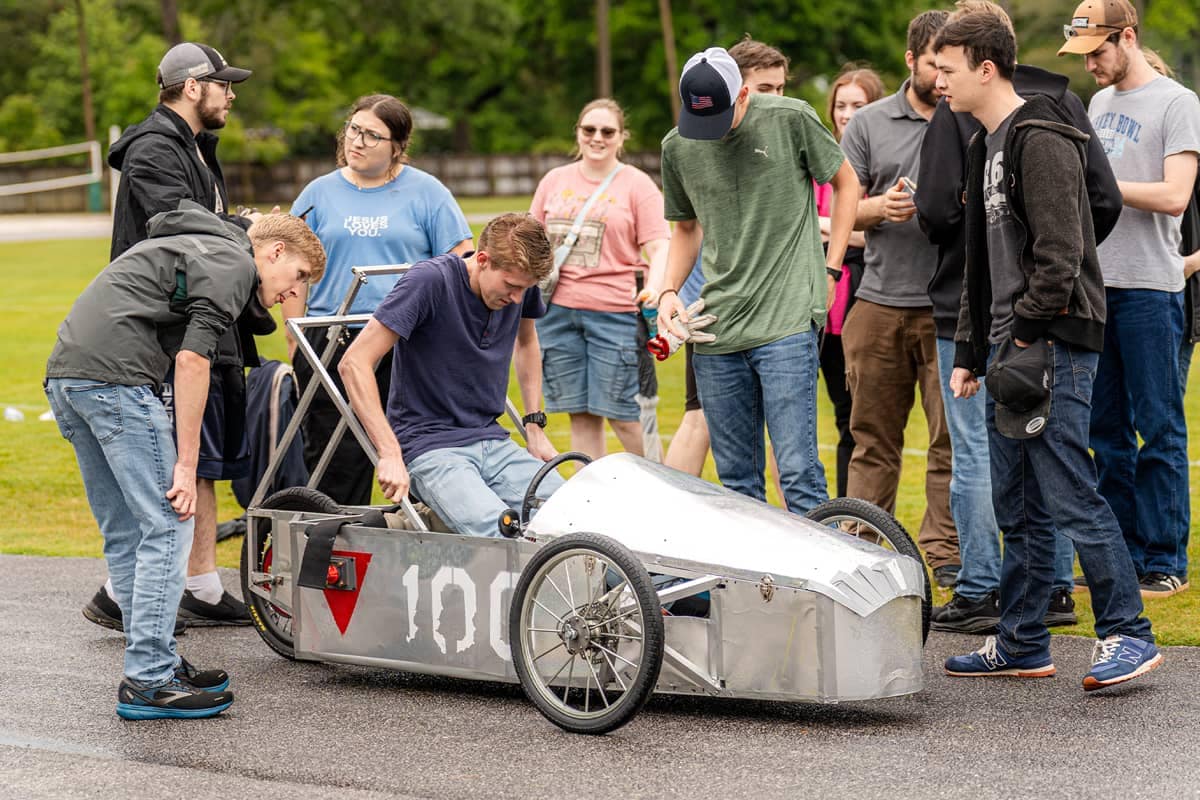 Engineering student in silver vehicle