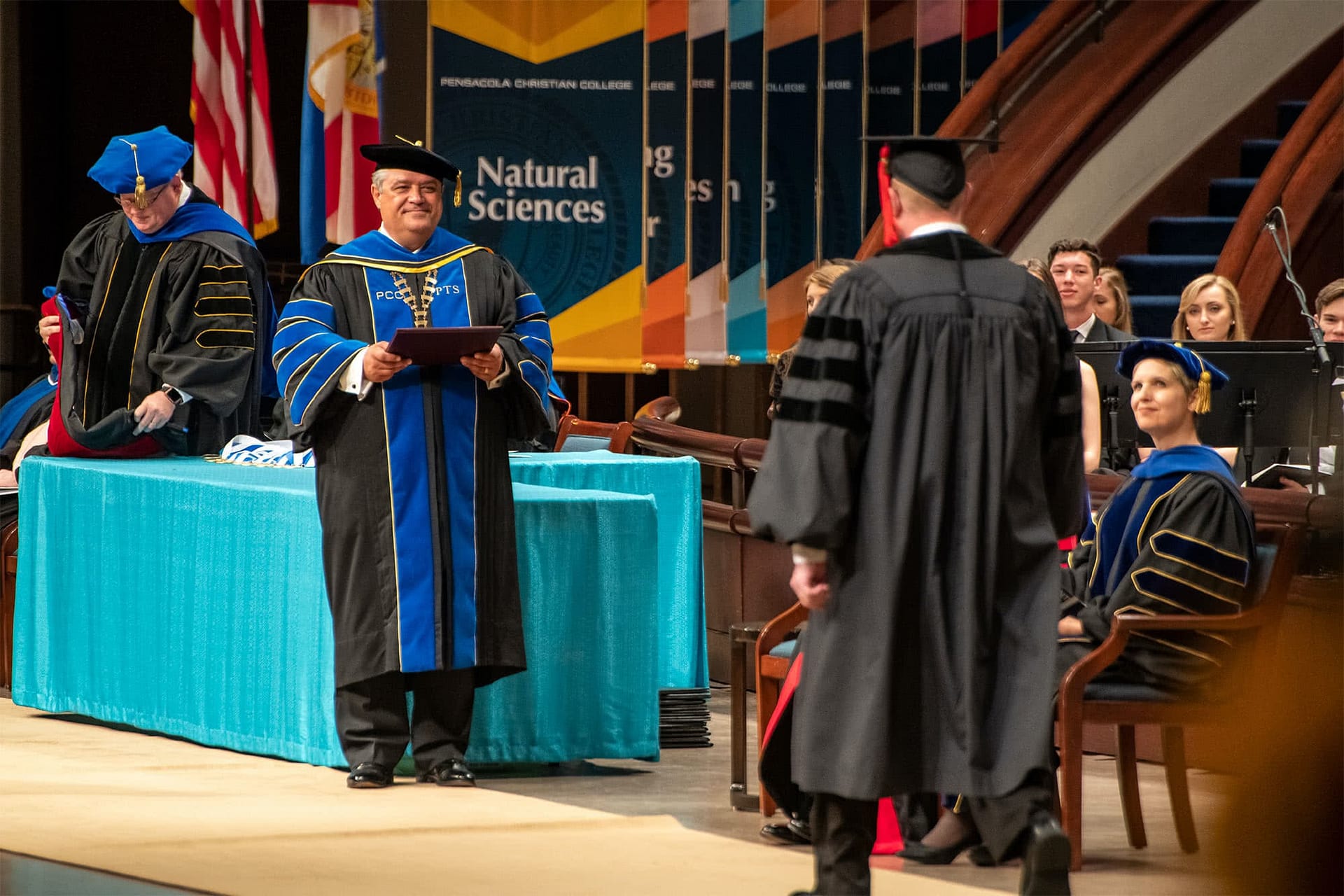 Dr. Shoemaker hands an honorary doctorate diploma to this year's recipient
