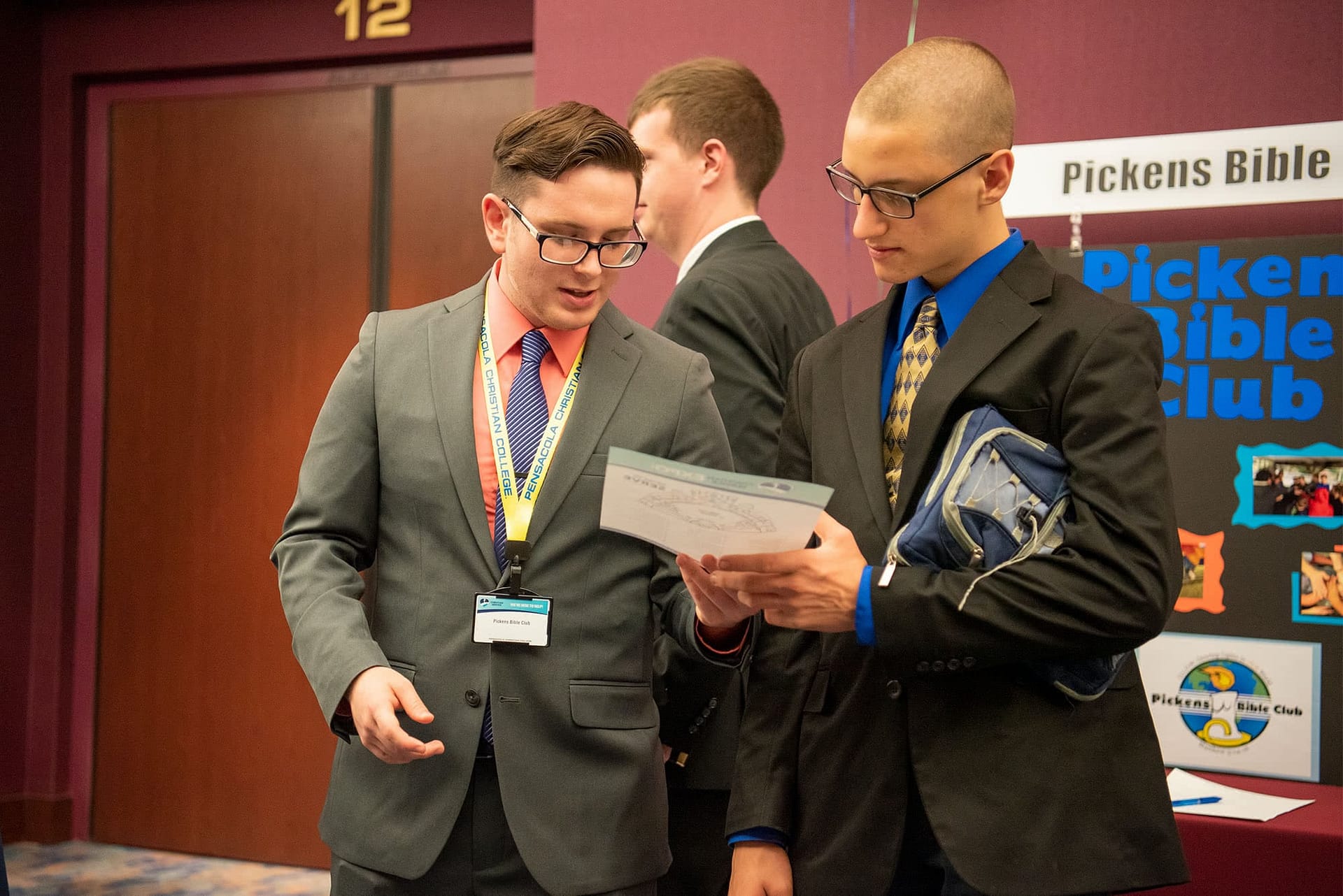Two guys try to find a Christian Service on the map of the Expo
