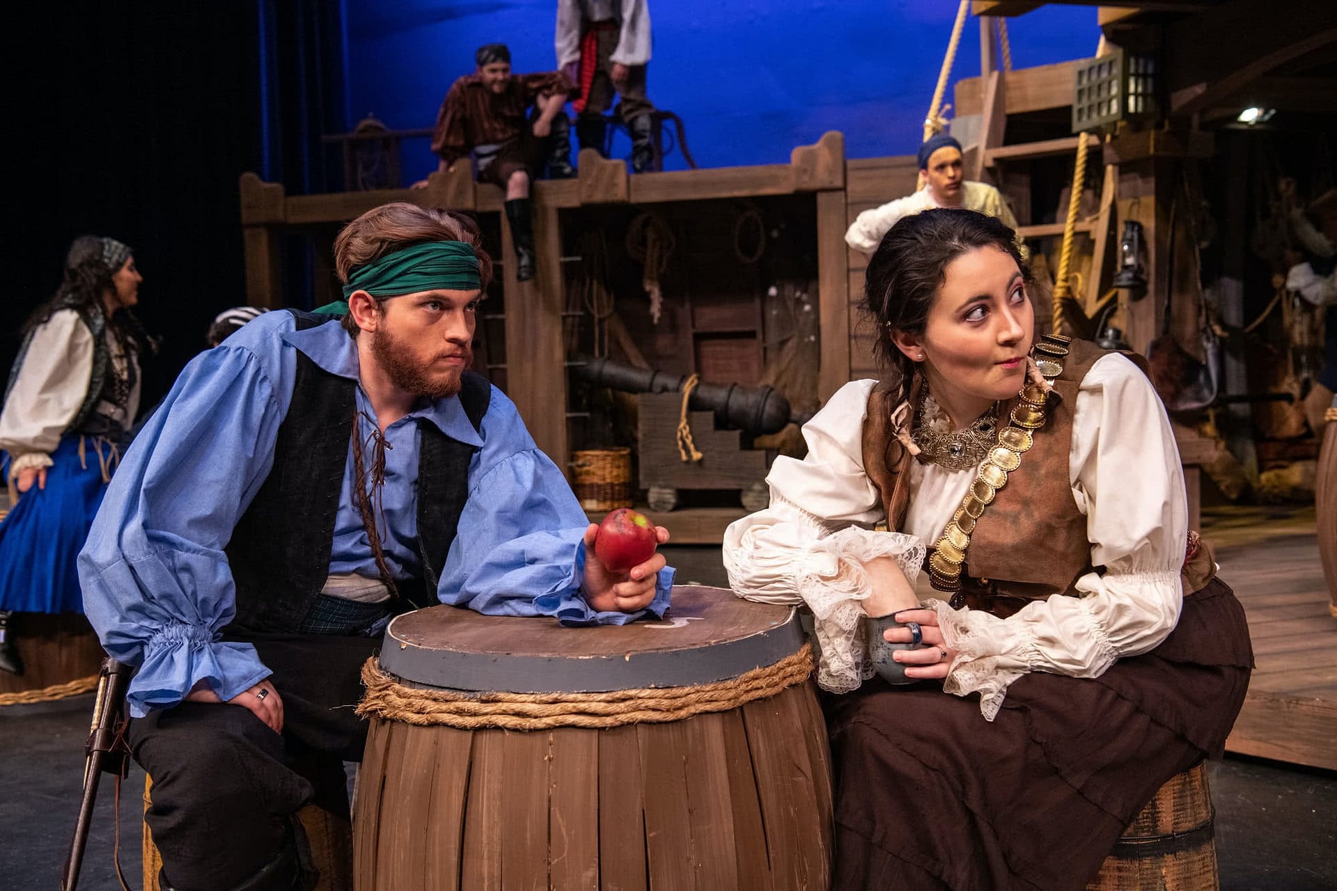 Two pirates watch an unfolding scene in PCC's Treasure Island.