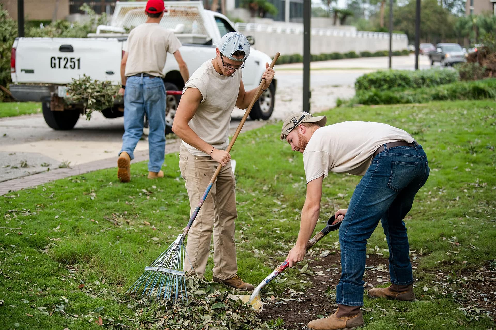 Grounds workers clean up debris