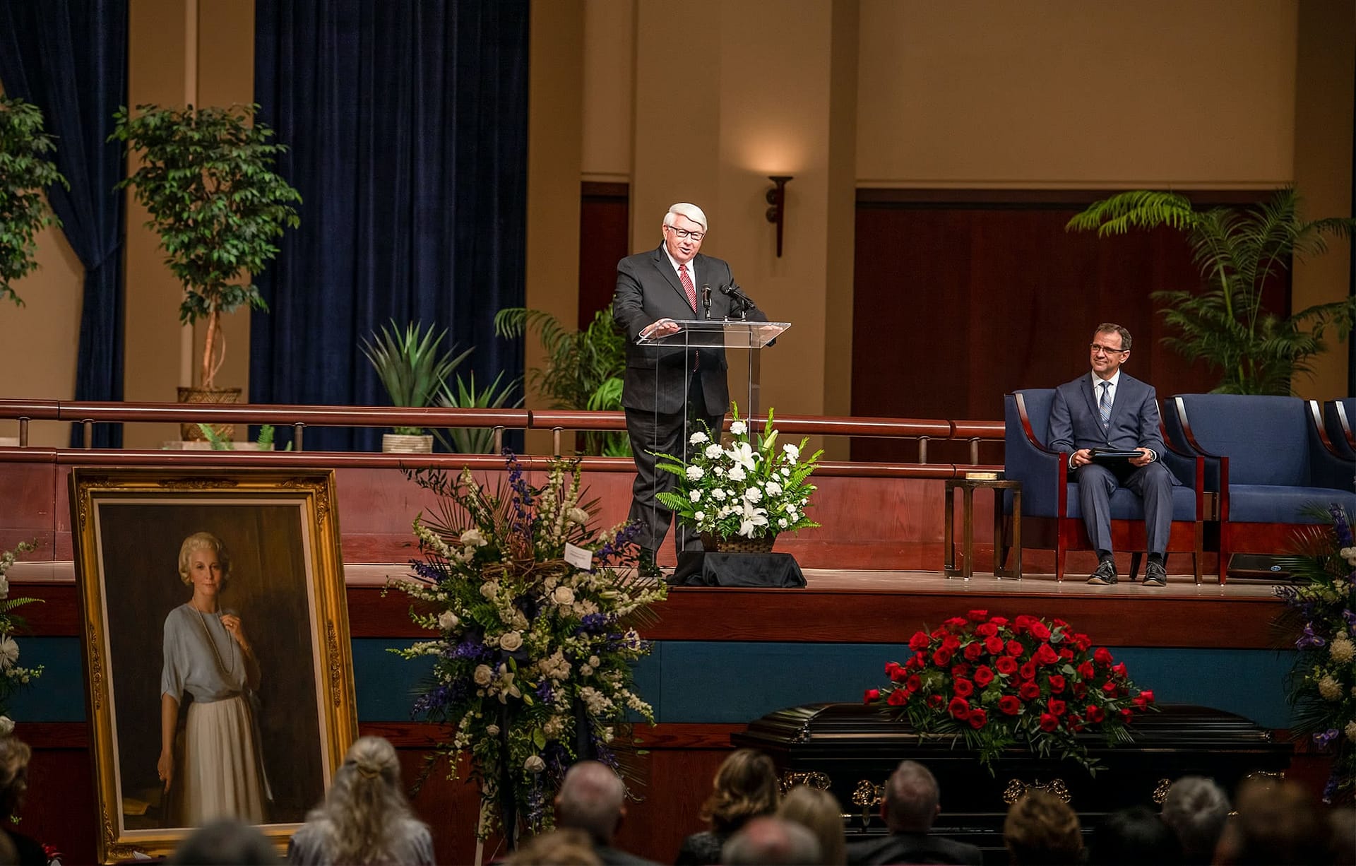 Dr. Joel Mullenix speaking on stage.