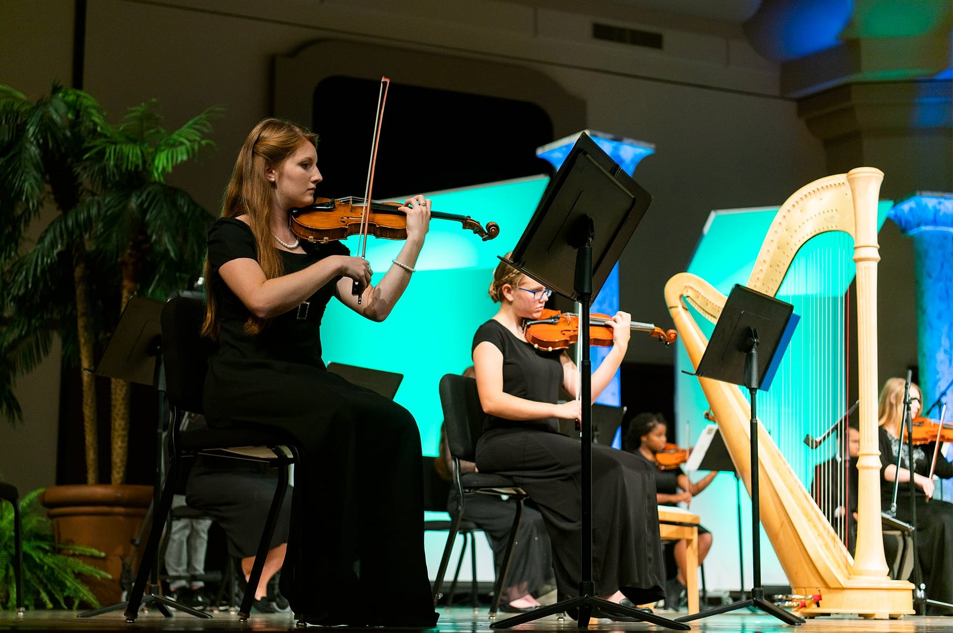 Two female students playing violin.