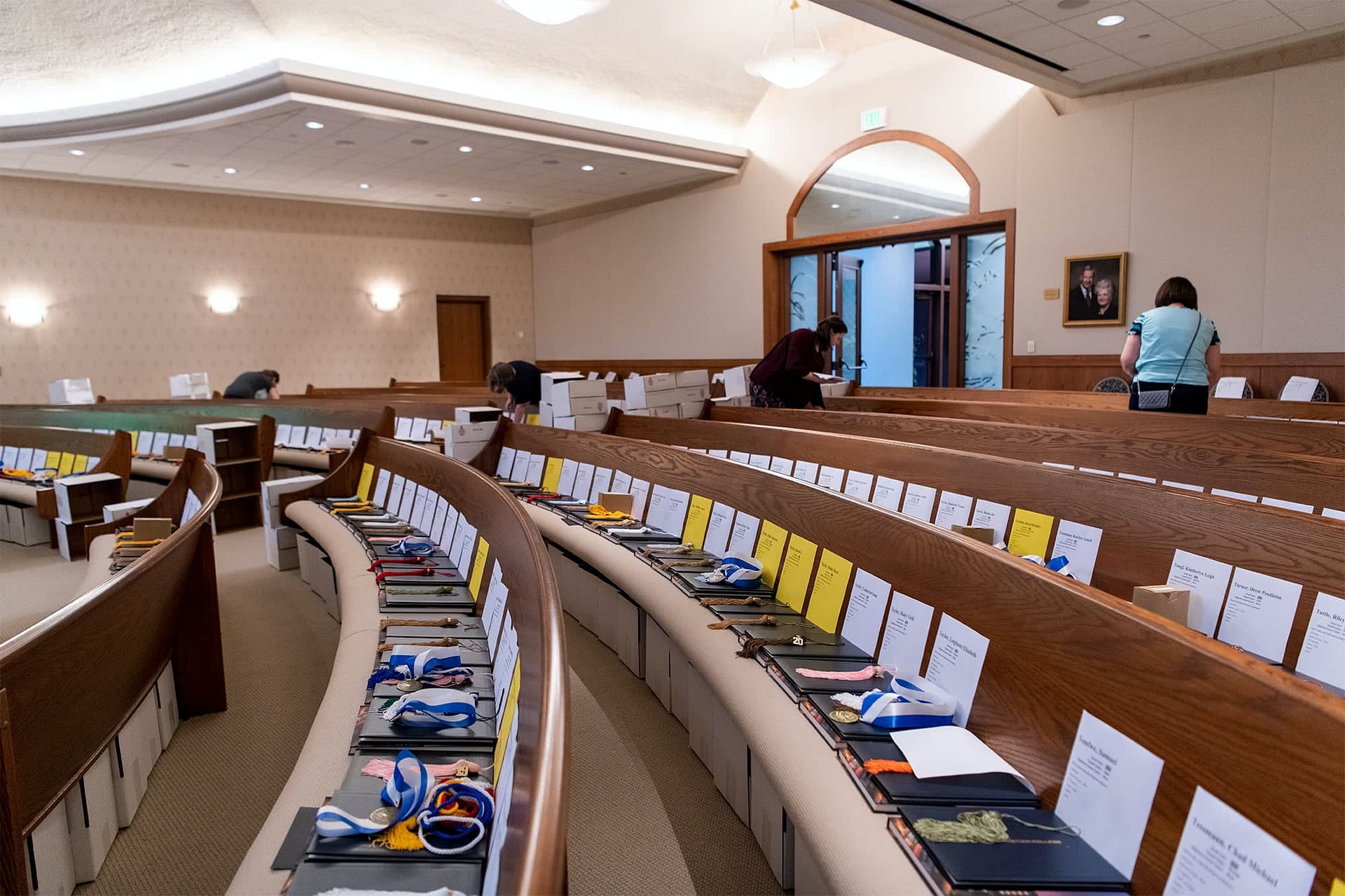 PCC graduates' diplomas laid across pews.