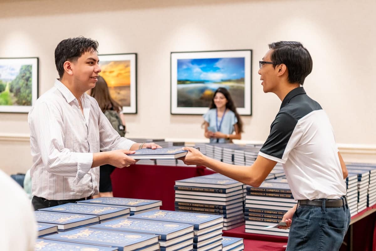 PCC student receives a copy of the 2024 Summit Yearbook