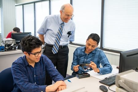 Dr. Keith Francis works with students