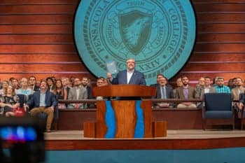 Dr. Shoemaker reveals the new Summit Yearbook in the dedication chapel