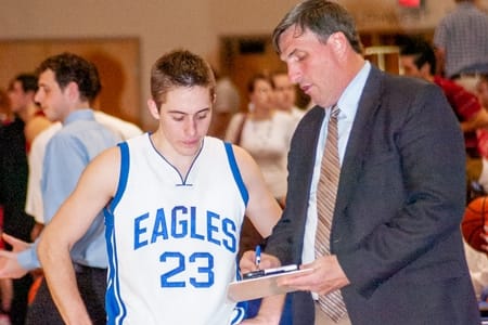 Coach Goetsch talking with men's Eagles player.