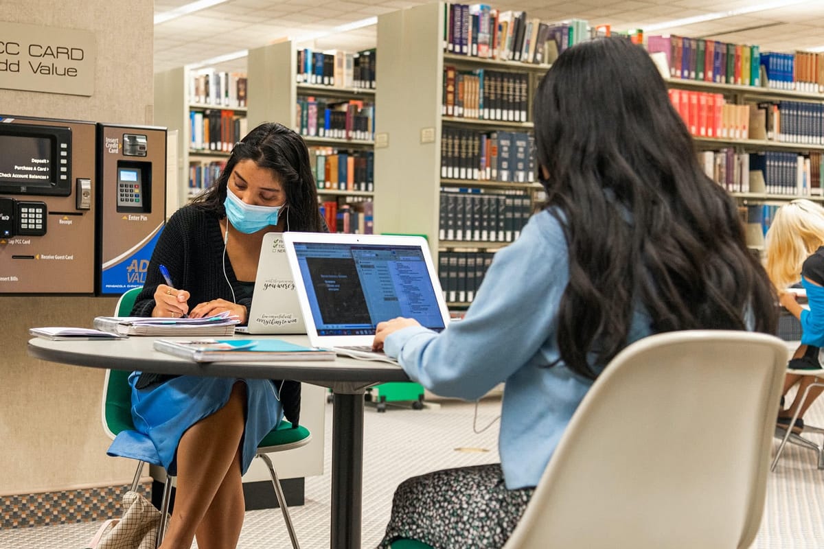 Two PCC girls studying in the Library