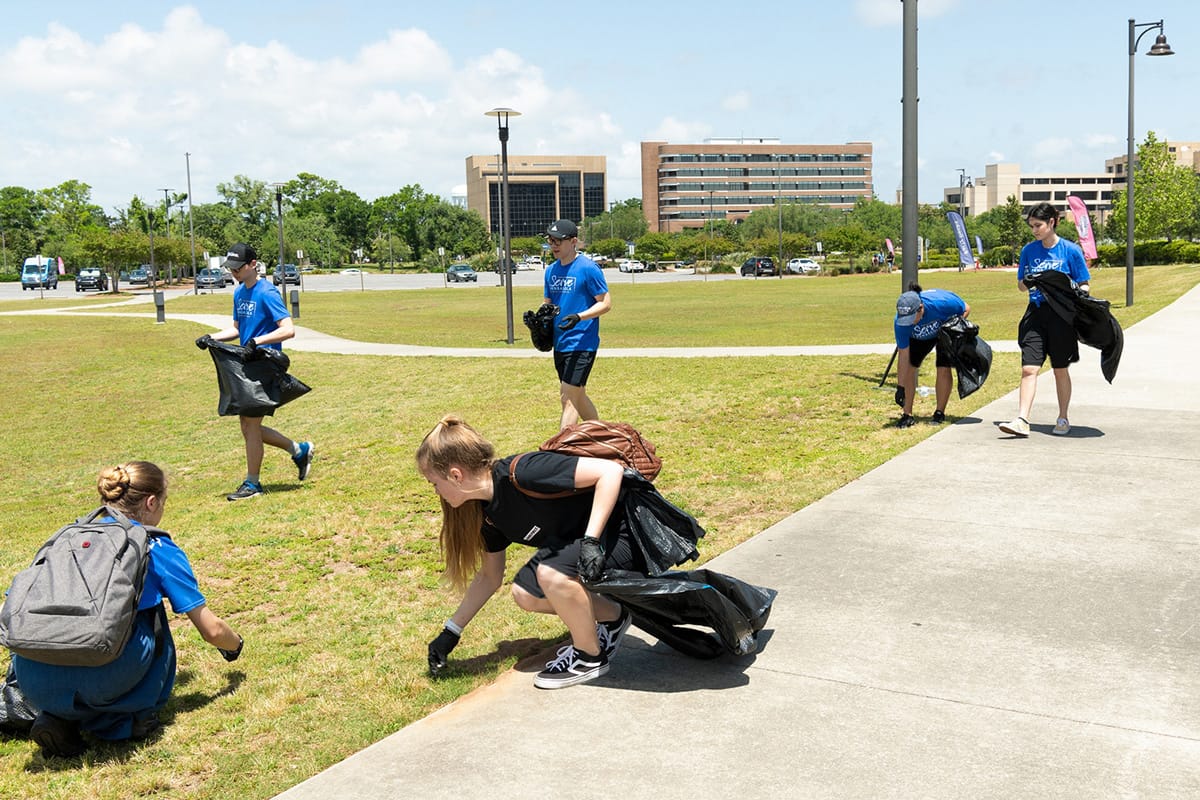 Picking up trash during Serve Pensacola Day