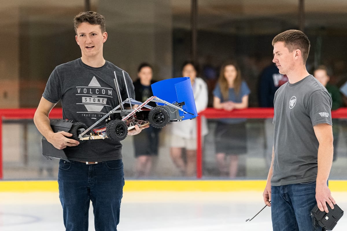 Students show their vehicle during Engineering Design Competition