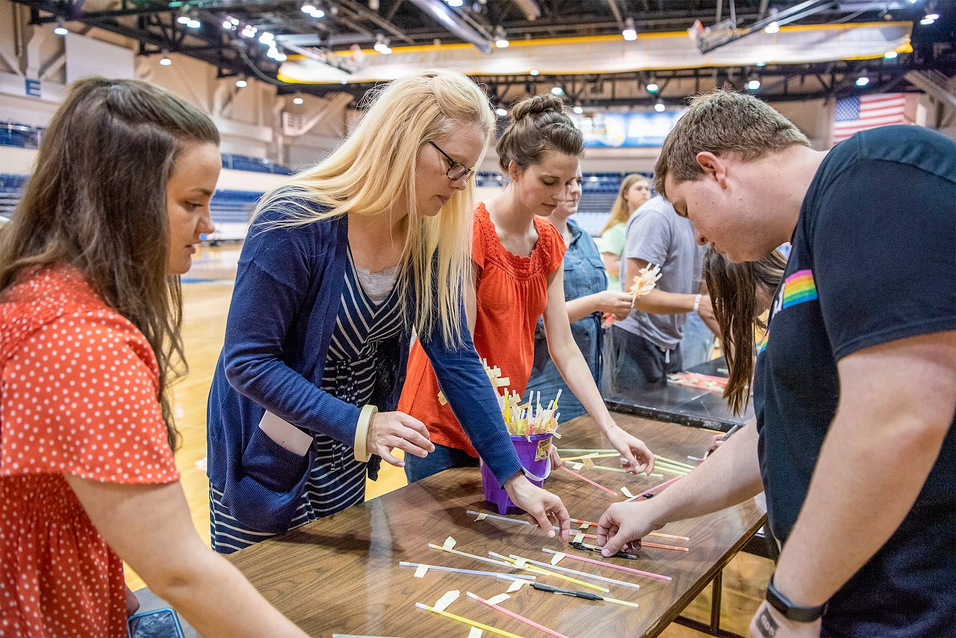 PCC students standing at a long table in the Sports Centre.