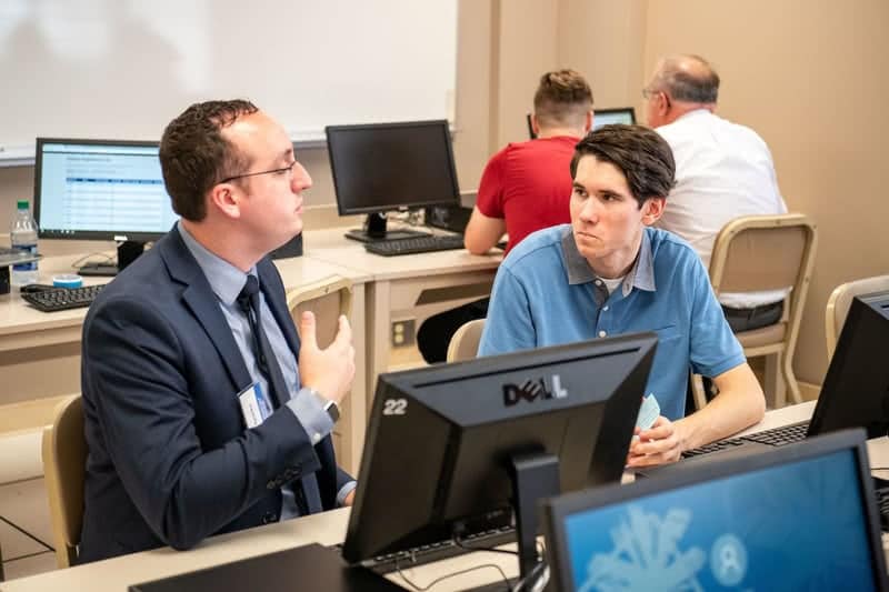 A faculty advisor gives academic support and helps a student register for classes