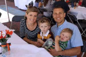 Jonathan Stormer sitting with his wife and two sons.