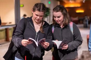 PCC girls look at the new 2024 Fountains Publication at the Fountains book sale