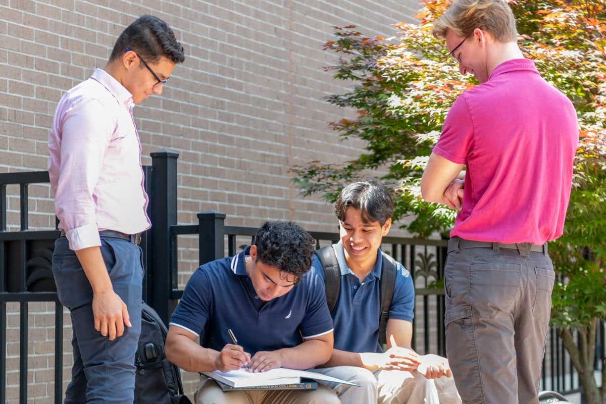 PCC Students sign each other's 2024 Summit Yearbooks