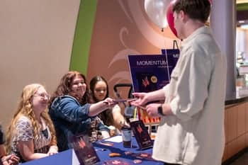 PCC student purchases the new 2024 Fountains Publication at the Fountains book sale