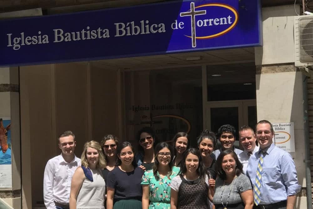 YOM missions team taking a photo in front of a church. 