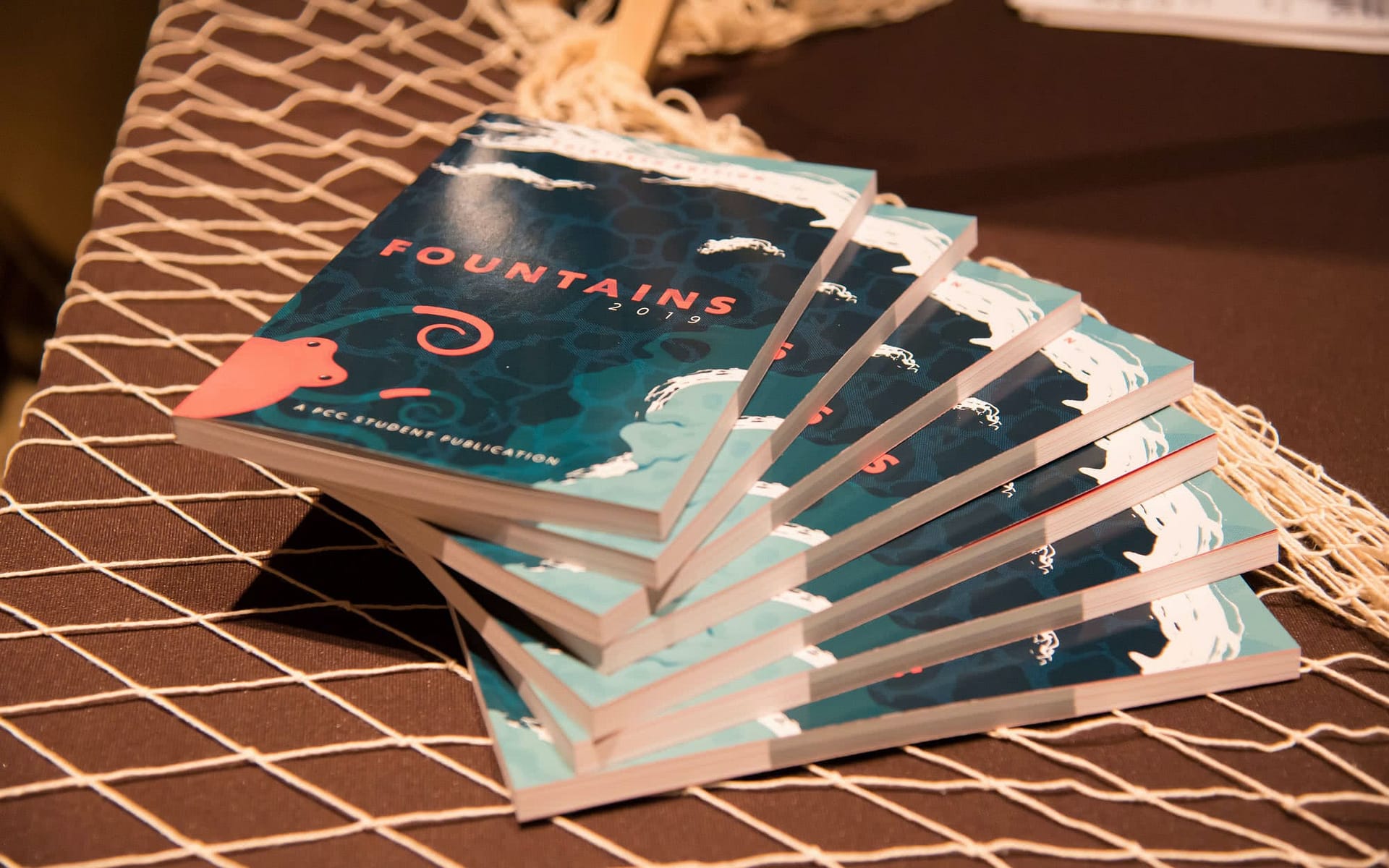 Copies of Fountains 2019 stacked together.