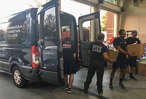 People unloading hurricane relief supplies.