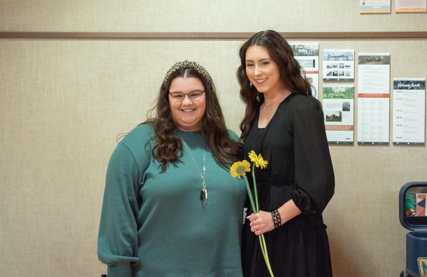 Rachel Wykle at her art exhibit with guest