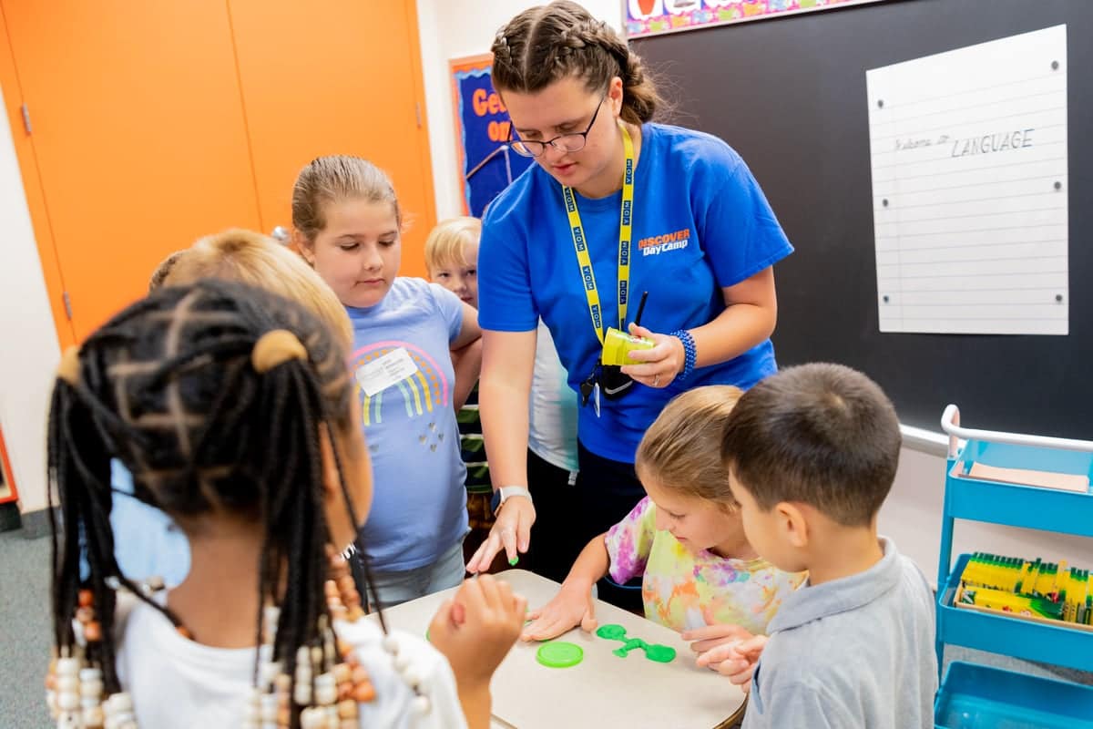 Discover Day Camp Worker interacting with campers