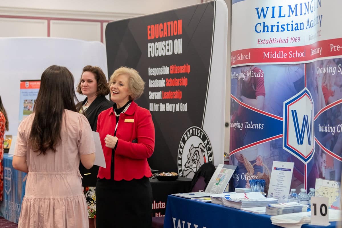 Girl talks to a recruiter at PCC's Educator Recruitment event