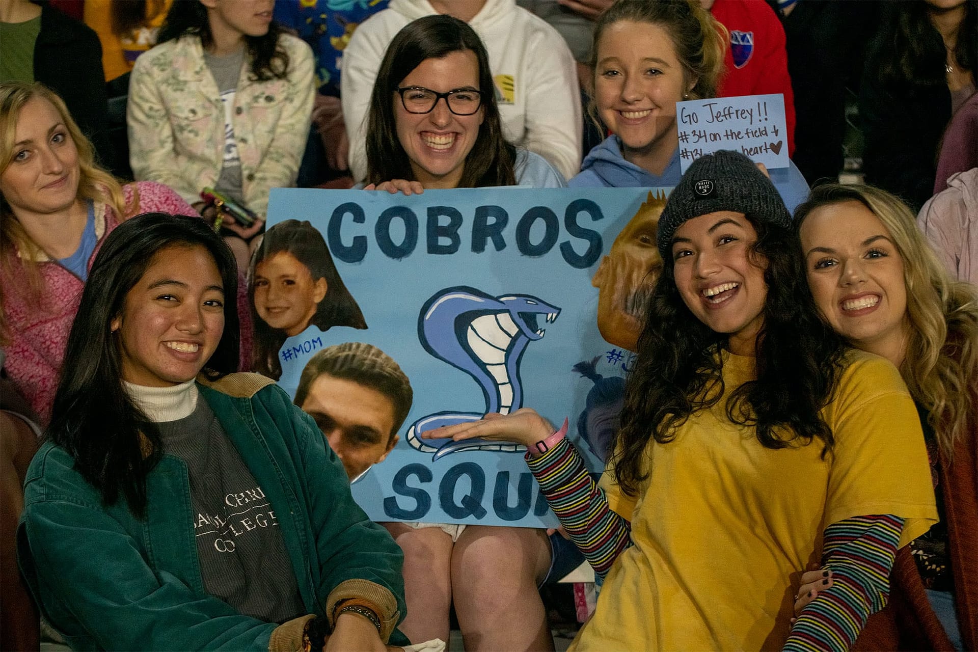 Watching students cheered on the Cobras with handmade signs