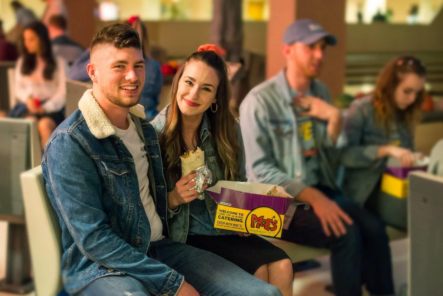 Two students sitting and eating together.