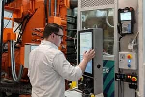 Engineer Lucas Haughey looking at a screen on a machine. 