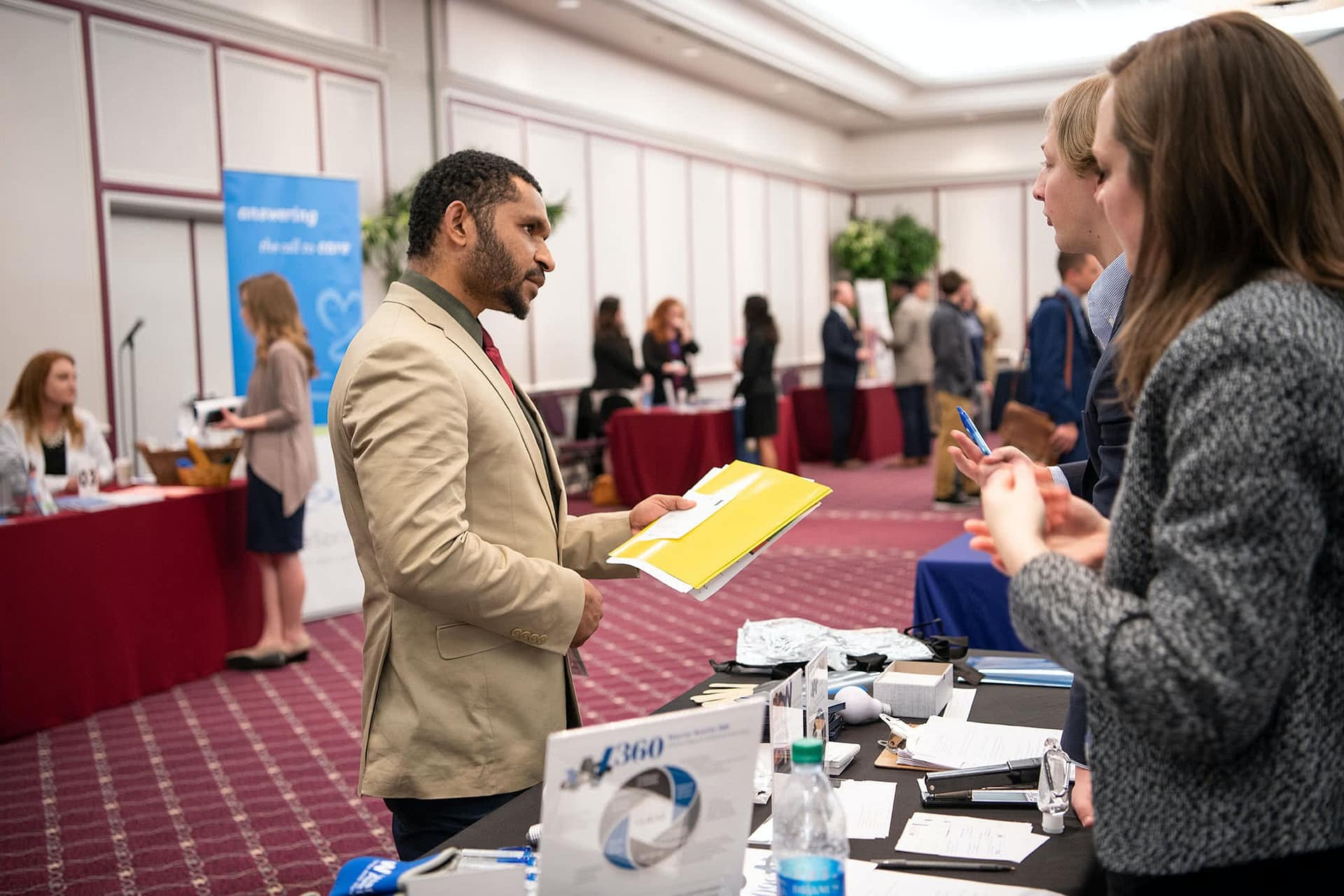 PCC senior speaking at a booth with a business representative at the 2020 Career Fair. 