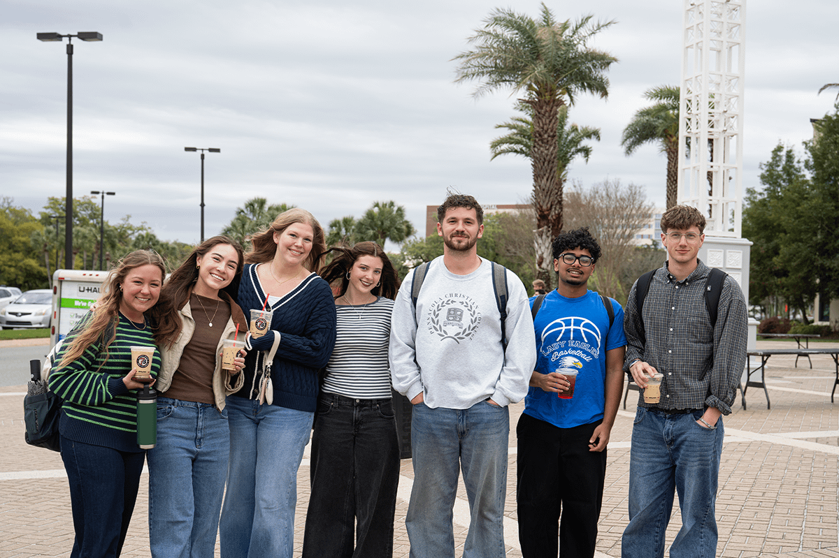 Friends pose in front of Crowne Centre