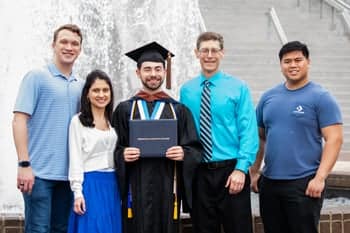 2024 Graduate and his family poses for a photo afterCommencement