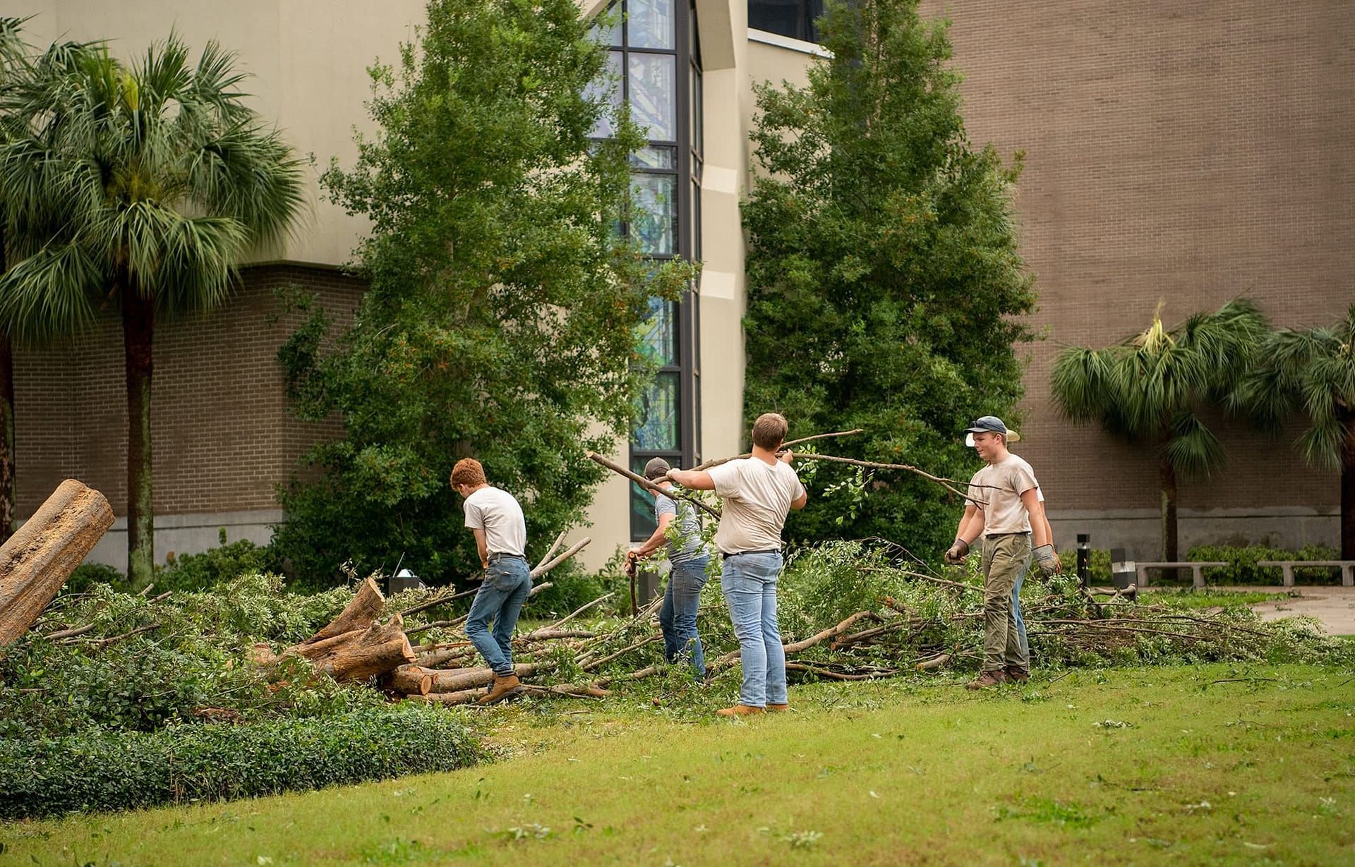 Grounds workers clean up outside of the Crowne Centre