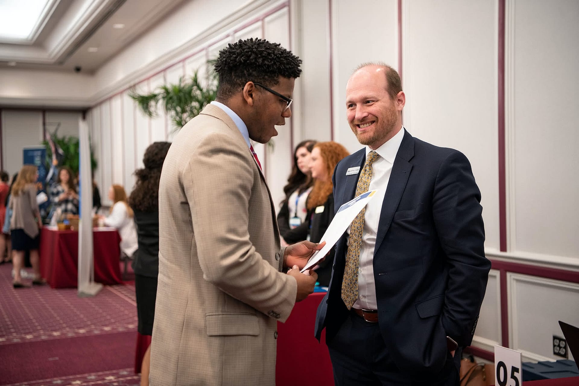 PCC senior speaking at a booth with a business representative at the 2020 Career Fair. 