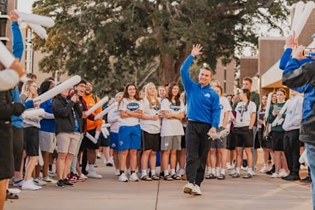 Coach-Sellars with Lady Eagles team welcomed by fans.