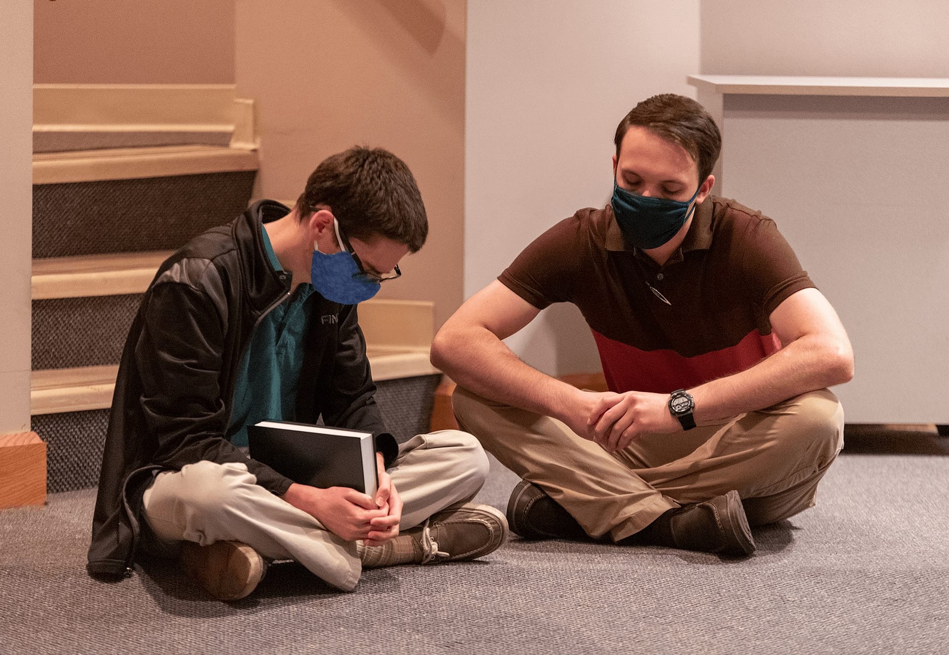 Two male students praying.