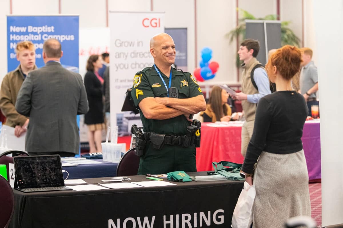PCC Student talks with a Police officer representative at the PCC Career Fair.