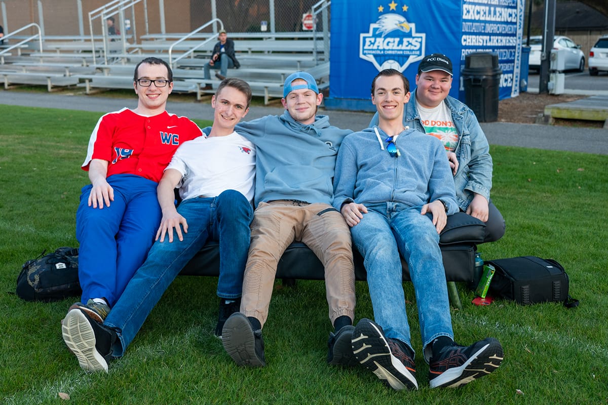 Students enjoy watching an outdoor movie